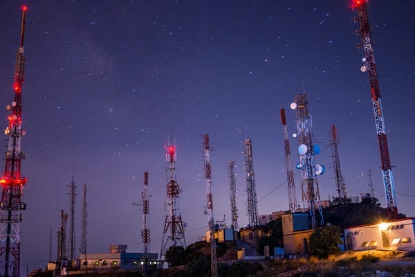 Cell towers with satellite dishes - starry sky backdrop