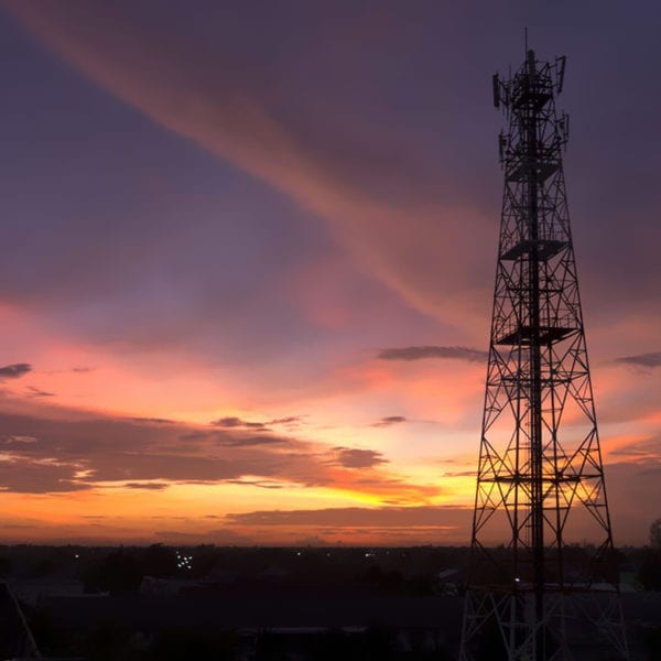 Cell tower with sunset sky in back